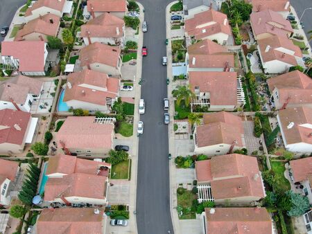 Aerial top view of urban sprawl. Suburban packed homes neighborhood with road. Vast subdivision in Irvine, California, USAの写真素材