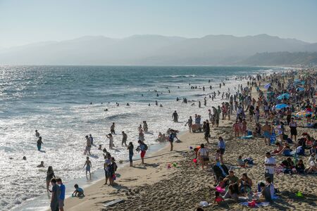Crowded Santa Monica beach with tourist and families enjoying the summer and hot weather. Santa...