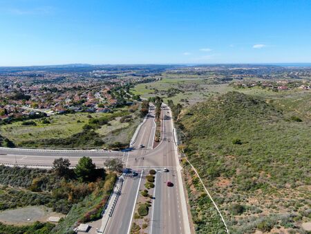 Curving road and downhill with houses in suburb of San Diego, California, USA
