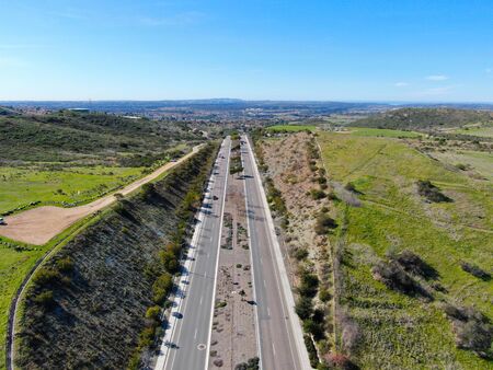 Curving road and downhill with houses in suburb of San Diego, California, USA