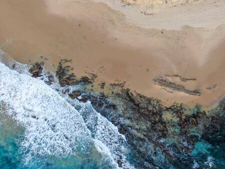Aerial top view of the ocean colorful waves washing on the coast of the Pacific ocean. California. USAの写真素材