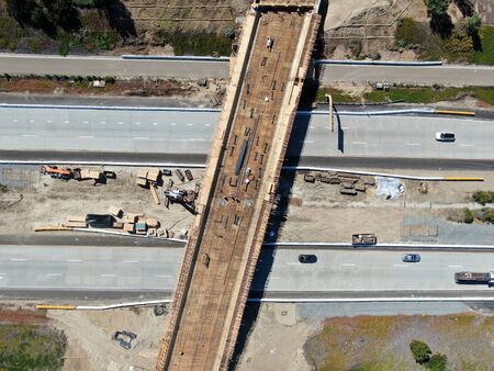 Aerial view of bridge construction crossing the highway, California, USA