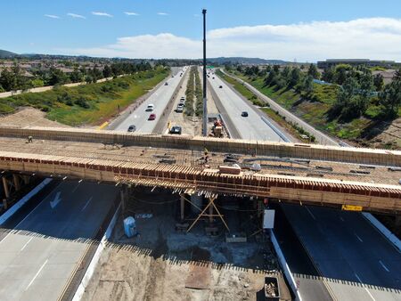 Aerial view of bridge construction crossing the highway, California, USA