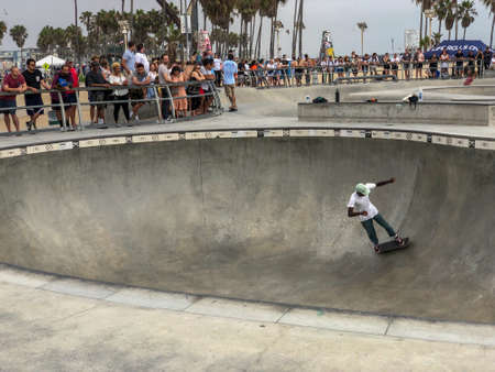 Skateboarder at Venice Beach skate park pool with crowd watching them. Famous tourist attraction at Venice Beach, California, USA. July 13th, 2019のeditorial素材