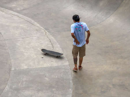 Skateboarder at Venice Beach skate park pool. Famous tourist attraction at Venice Beach, California, USA. July 13th, 2019のeditorial素材