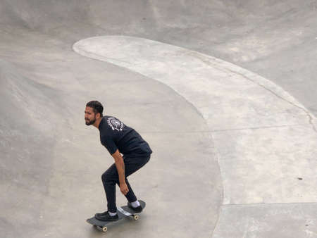 Skateboarder at Venice Beach skate park pool. Famous tourist attraction at Venice Beach, California,...