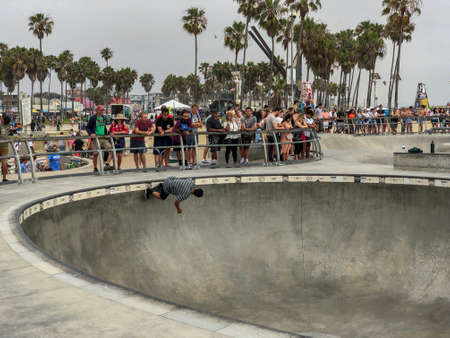 Skateboarder at Venice Beach skate park pool with crowd watching them. Famous tourist attraction at Venice Beach, California, USA. July 13th, 2019のeditorial素材