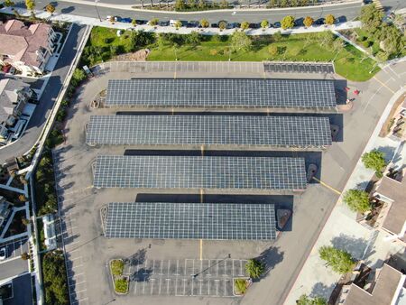 Aerial view of solar power plant installed on top of a parking lot. Renewable Energy: Solar Panels...