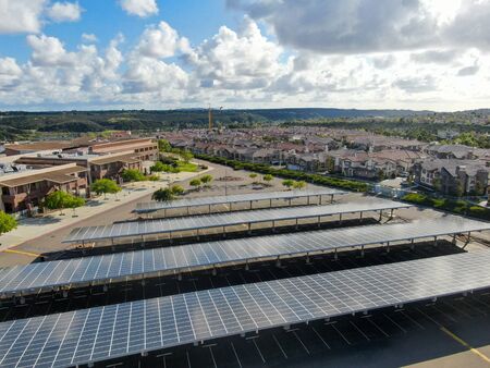 Aerial view of solar power plant installed on top of a parking lot. Renewable Energy: Solar Panels...