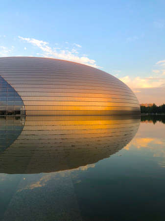 Sunset Panorama with The National Performing Arts Center in Beijing formerly the Beijing National Grand Theater. Futuristic design, one of the most famous landmarks of Beijing, China. July 13th 2019のeditorial素材
