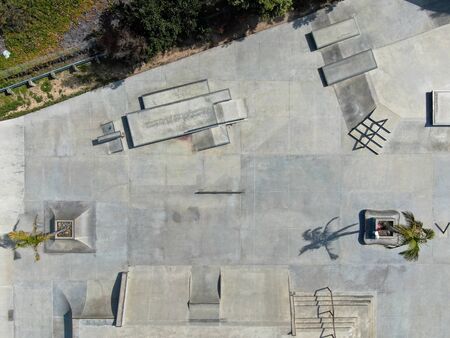 Aerial view of outdoor empty concrete skate park with ramps and pipes in California. USAの写真素材