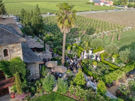 Aerial view of V. Sattui Winery and retail store, St. Helena, Napa Valley, California, USA. People enjoying drink and wedding event in the green garden surrounded by vineyard. May 18th, 2019のeditorial素材