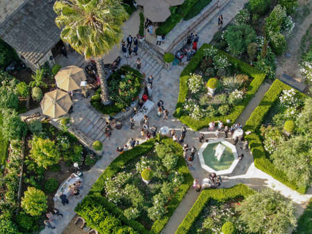 Aerial view of V. Sattui Winery and retail store, St. Helena, Napa Valley, California, USA. People enjoying drink and wedding event in the green garden surrounded by vineyard. May 18th, 2019のeditorial素材