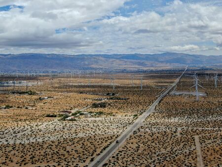 Aerial view of huge array of gigantic wind turbines spreading over the desert in Palm Springs wind...