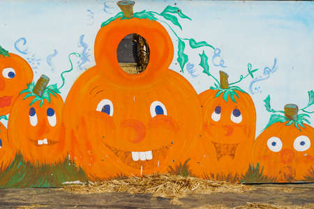 Photo board with pumpkins face cutouts for family photography fun at Halloween fair, San Diego, California, USA, October 22nd, 2019のeditorial素材