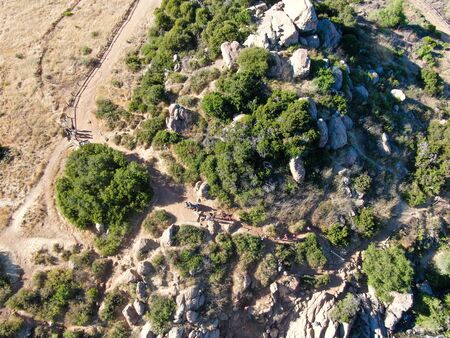 Aerial view of Los Penasquitos Canyon Preserve with tourist and hikers looking at the view. Urban...