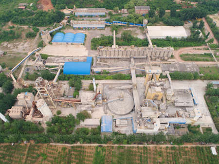 Aerial view of dusty factory with mountain on the background, Huaibei, China. industrial pollution. June 4th, 2020のeditorial素材