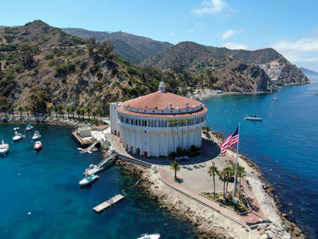 Aerial view of Catalina Casino and Avalon harbor with sailboats, fishing boats and yachts moored in calm bay, famous tourist attraction in Santa Catalina Island, Southern California. June 20th, 2020のeditorial素材