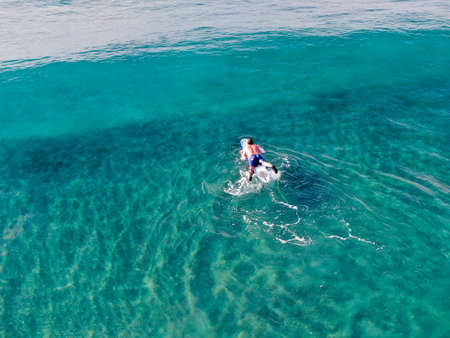 Aerial view of surfers waiting, paddling and enjoying waves in a beautiful blue water in La Jolla, San Diego, California, USA. July 1st, 2019のeditorial素材