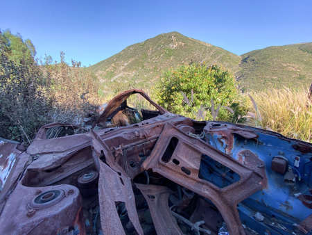 Rustic abandoned car in the mountain against blue sky, San Diego, Californiaの写真素材