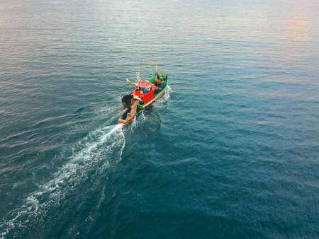 Aerial view of traditional fisher boat in the sea. Fishing boat on duty in mid sea. Fisherman Boat...