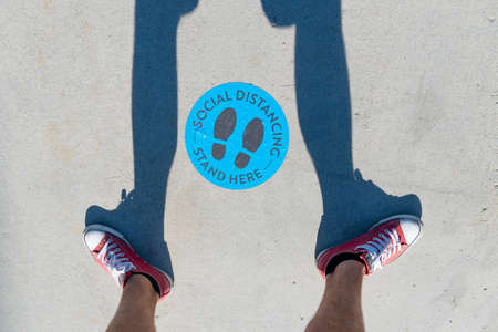 Coronavirus COVID 19 keep safe social distancing sticker on the floor