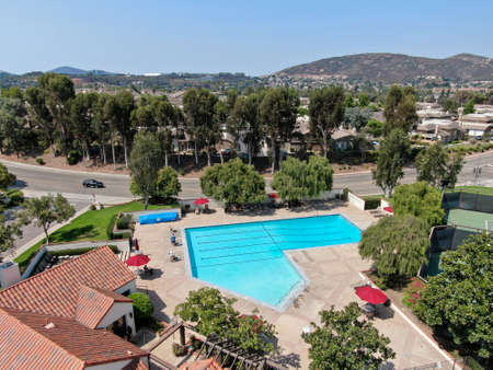 Aerial view swimming pool and tennis court in middle class neighborhood community in Rancho Bernardo, South California, USA. August 22nd, 2020のeditorial素材