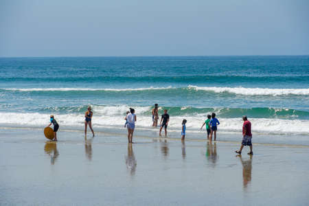 Tourist and families on the beach enjoying beautiful summer day at Huntington Beach, California. USA...