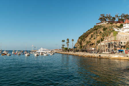 Avalon harbor in Santa Catalina Island with sailboats, fishing boats and yachts moored in calm bay, famous tourist attraction in Southern California, USA. June 20th, 2020のeditorial素材