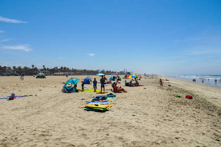 Tourist and families on the beach enjoying beautiful summer day at Huntington Beach, California. USA...