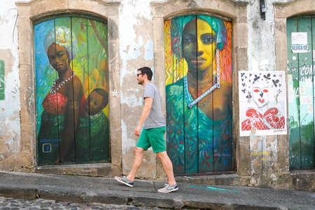 Tourist walking in the colorful historic district of Pelourinho, Bahia, Brazil. Historic neighborhood famous attraction for tourist sightseeing. February 11th, 2020のeditorial素材