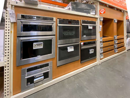 Wall of ovens, home appliances selection at retail store, rows of home appliances equipment. San Diego, California, USA. October 20th, 2020のeditorial素材