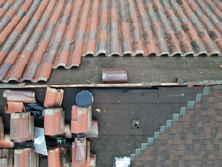 Aerial view over red tile roof repair workの写真素材