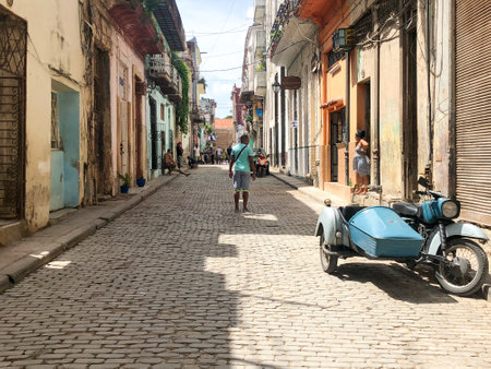 Street scene with colorful and old building on Havana. Urban scene with people and aged buildings in Old Havana. Cuba. February 21st, 2020のeditorial素材