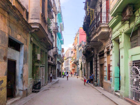 Street scene with colorful and old building on Havana. Urban scene with people and aged buildings in Old Havana. Cuba. February 21st, 2020のeditorial素材