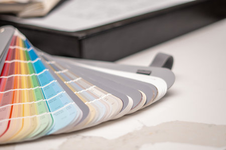 Interior designers working table, an architectural plan of the house, a color palette, furniture and...