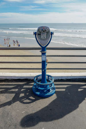 Sightseeing retro style binoculars with beach background Oceanside Pier in San Diego, California,...