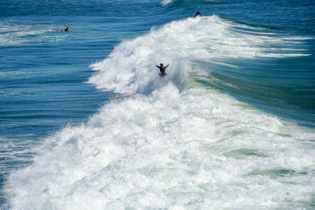 Male surfers enjoying the big wave in Oceanside in North San Diego, California, USA. Travel destination in the South West Coast famous for surfer. January 2n, 2021のeditorial素材
