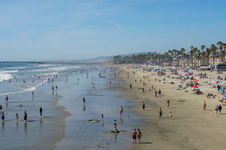 People on the beach enjoying beautiful summer day at Oceanside beach in San Diego, California.のeditorial素材