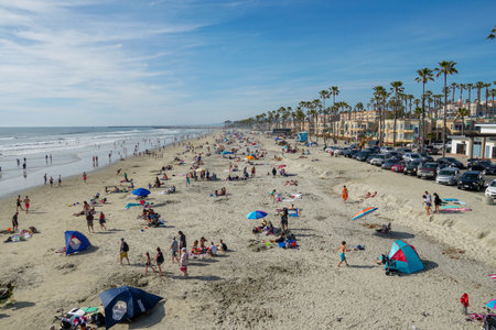 People on the beach enjoying beautiful summer day at Oceanside beach in San Diego, California.のeditorial素材