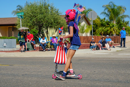 Young girls with American flag parading at the 4th of July Independence Day parade in Rancho Bernardo, San Diego, California, USA. July 4th 2019のeditorial素材