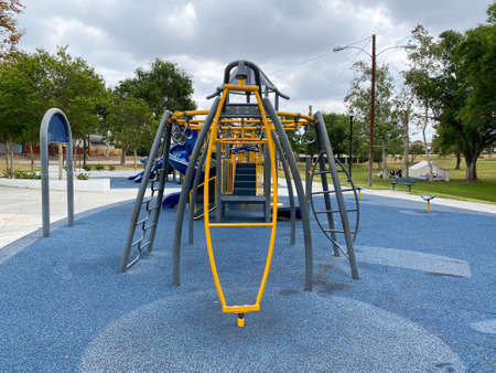 Slide, swing on modern playground. Children playground activities in public park. Urban neighborhood...