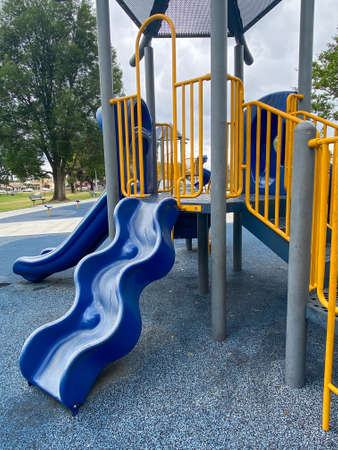 Slide, swing on modern playground. Children playground activities in public park. Urban neighborhood childhood concept.の写真素材