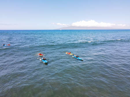 Aerial view of surfers and waves in crystal blue ocean in Maui, Hawaii, USAの写真素材