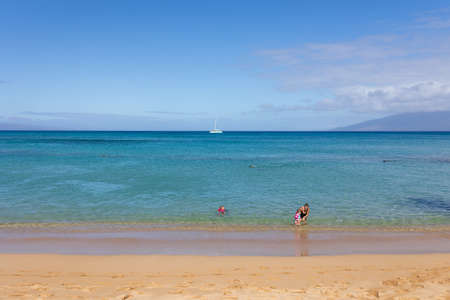 Tourist enjoying tropical beach with white sand and crystal clear water in Maui, Hawaii, USA, August 22nd, 2021のeditorial素材
