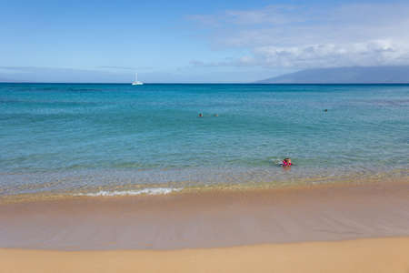 Tourist swimming at tropical beach with white sand and crystal clear water in Maui, Hawaii, USA, August 22nd, 2021のeditorial素材