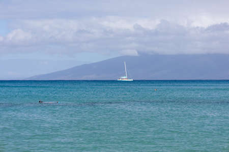 Sailboat in the open sea. Calm sea sailing, luxury summer adventure, active vacations. Maui, Hawaiiの写真素材