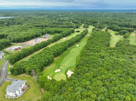 Aerial view of golf in the Suburban neighborhood in Sharon, Norfolk County, Massachusetts, with green forestの写真素材