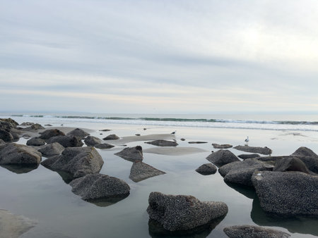 Stunning view at beach with coastal rocks and clear ocean water. High quality photo