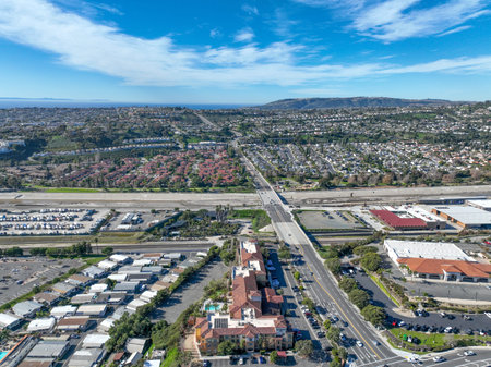 Aerial view over San Juan Capistrano, California, featuring the historic mission, library, sports...